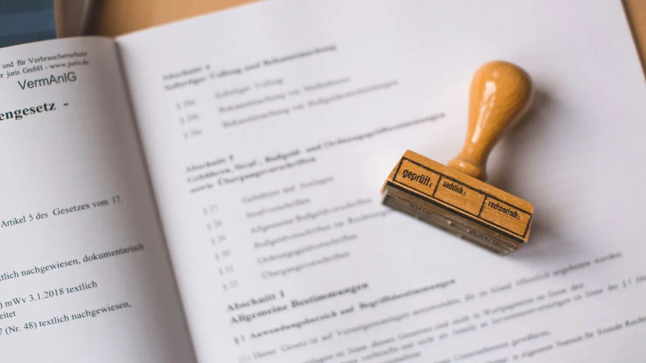 A wooden rubber stamp resting on an open legal document